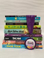 A stack of colorful kids and teen books sits on a beige surface and background. A medal with a purple ribbon and the colorful Summer Reading logo is draped across the stack of books.