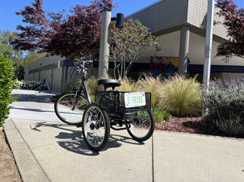 E-trike with large cargo basket parked in front of the Colonial Heights Library